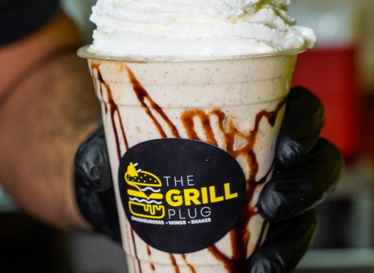 Close up of a milkshake topped with whipped cream